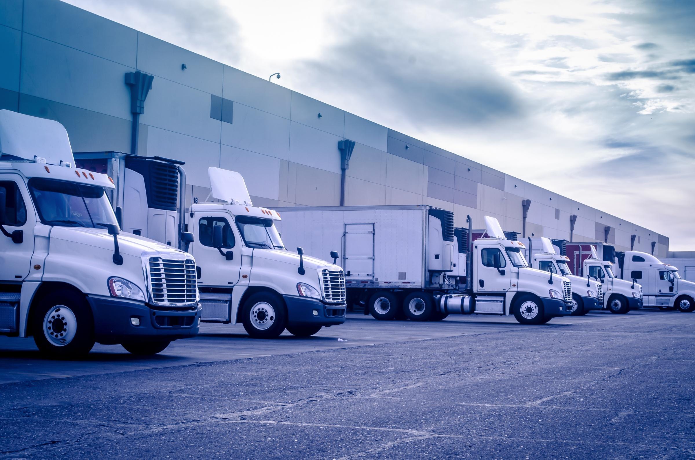 Trucks loading and unloading at Fulfillment by Amazon center